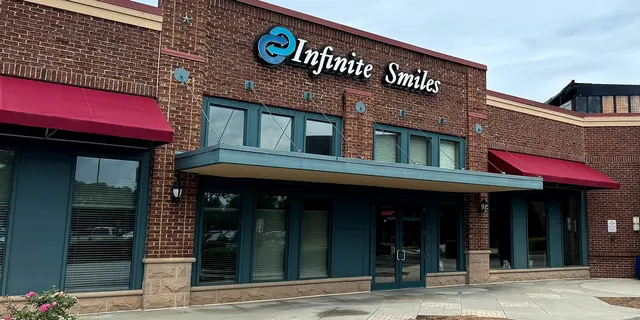 The Infinite Smiles storefront and sign on Medlock Bridge Road